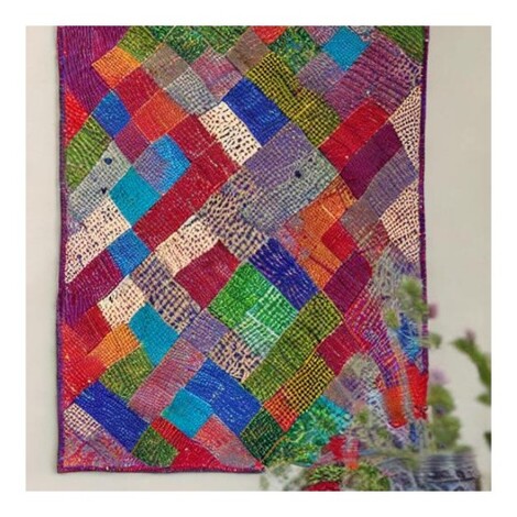 A vibrant Kantha Quilt Wall Hanging with different coloured fabric pieces arranged and sewn together with running stitches.