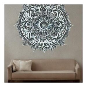 Mandala-inspired wall art with intricate stenciled pattern in white and light blue paint on a dark blue wall.
